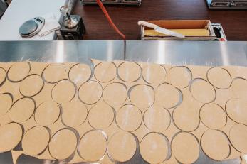 Table for of empanadas dough cut into circles.