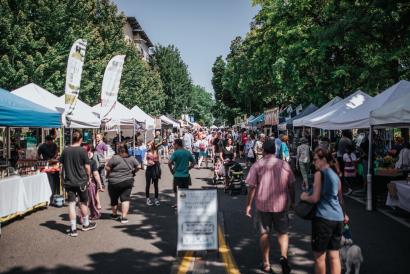 farmer's market booths on a street on a sunny day