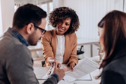 woman talks with man and woman about professional topic