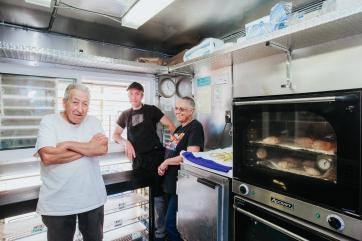 Family inside empanadas kitchen.