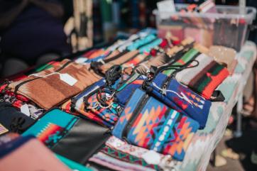 Display of beaded wallets at farmer's market.