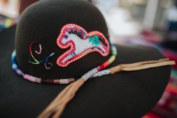 Display of beaded hat patch on a hat.