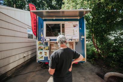 Man stands in front of food truck.