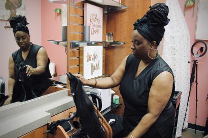 Woman in beauty salon holding hair extension