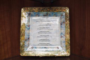 A decorative plate featuring a faith-based poem.