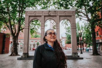 Woman stands in downtown portland posing for a headshot