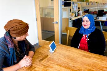 Two women sitting at a conference table