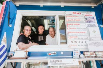 A family looking out from their food truck.