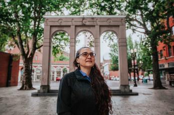 Woman standing in urban setting.