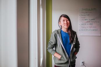 Woman smiling in a classroom.