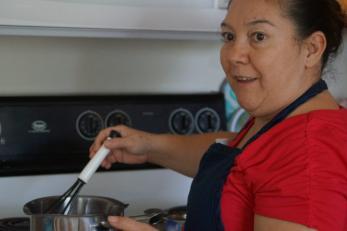 Beatriz Mercado cooking at stove