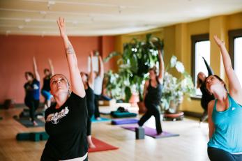 Several people participating in a yoga class