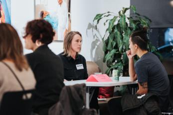 Two adults at a small meeting table