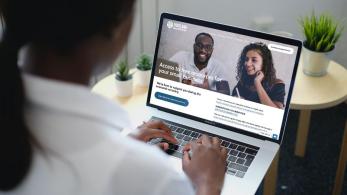 Woman looking at portland small business hub webpage on laptop