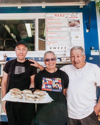 Family in front of their food cart.