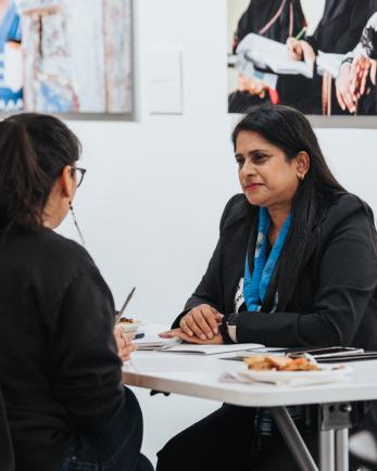 two business women sit at a table