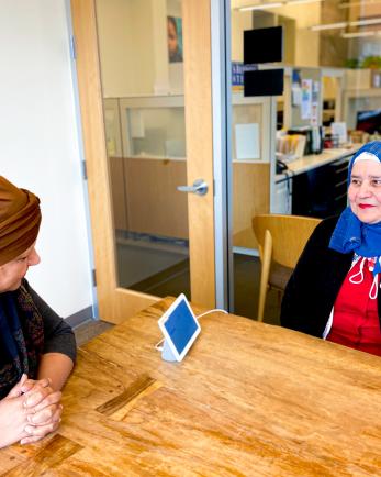 two women sitting at a conference table