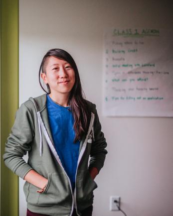 Woman smiling in a classroom.
