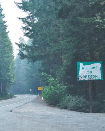 Welcome to Oregon sign outside of forest
